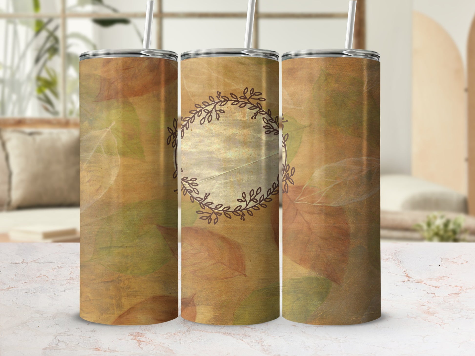 Three tumblers with a fall leaf design and a central circular emblem.