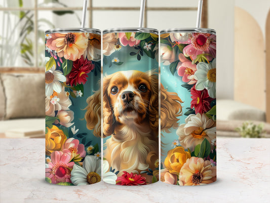 Cavalier King Charles Spaniel surrounded by colorful flowers on a tumbler.