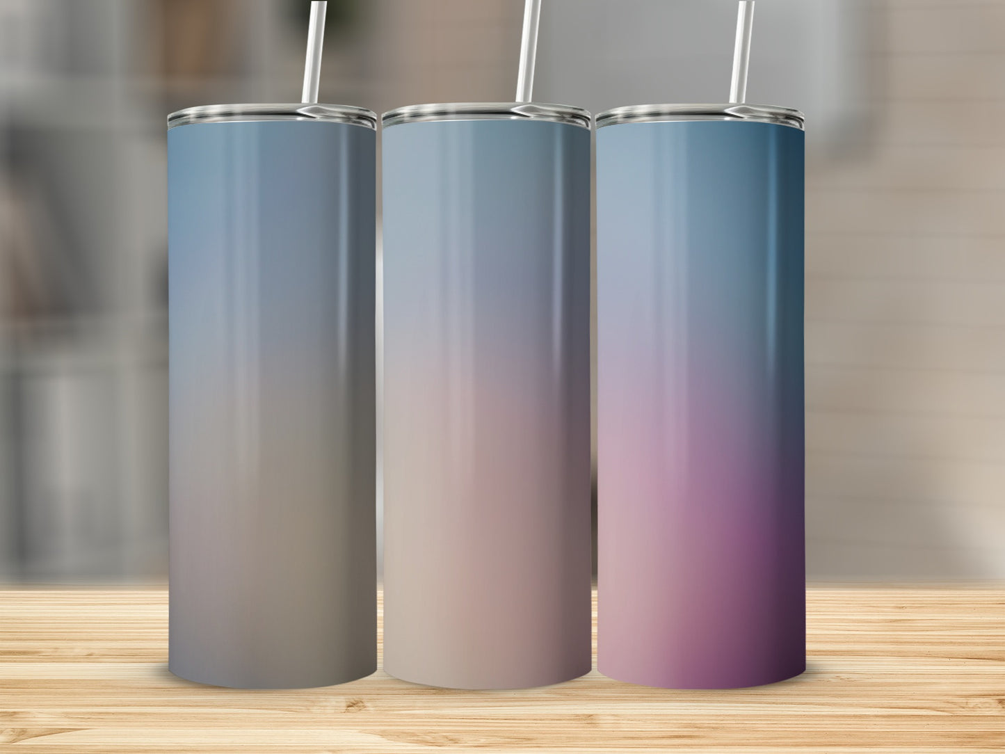 Three tall tumblers with a blue-to-pink gradient on a wooden surface.