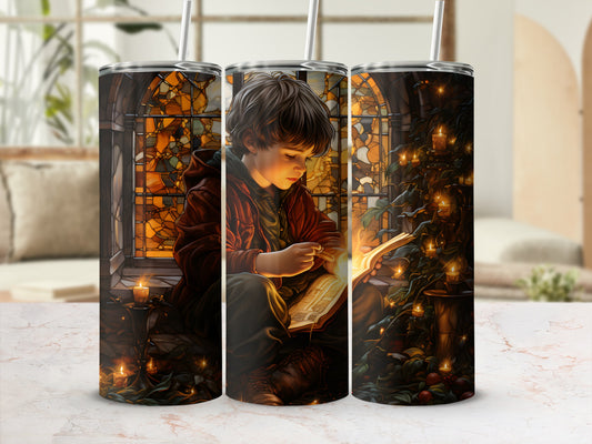 Boy reading by candlelight with stained glass window and holiday greenery.