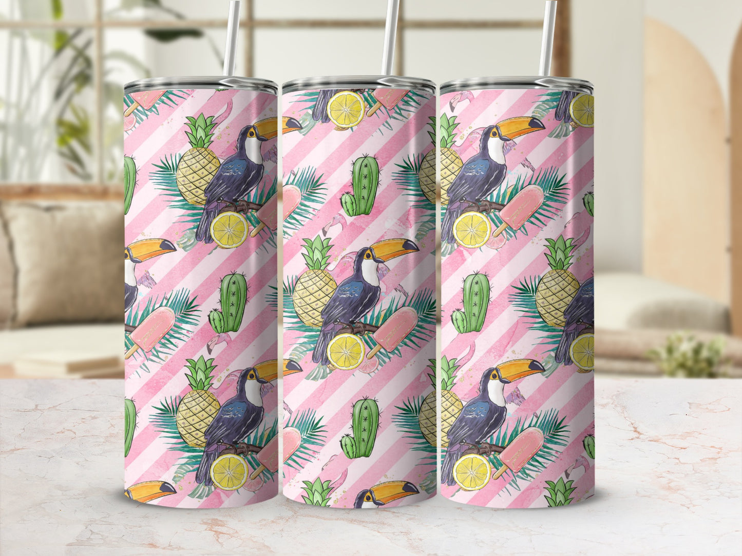 Toucan and flamingo tropical pattern on three tumblers with straws.