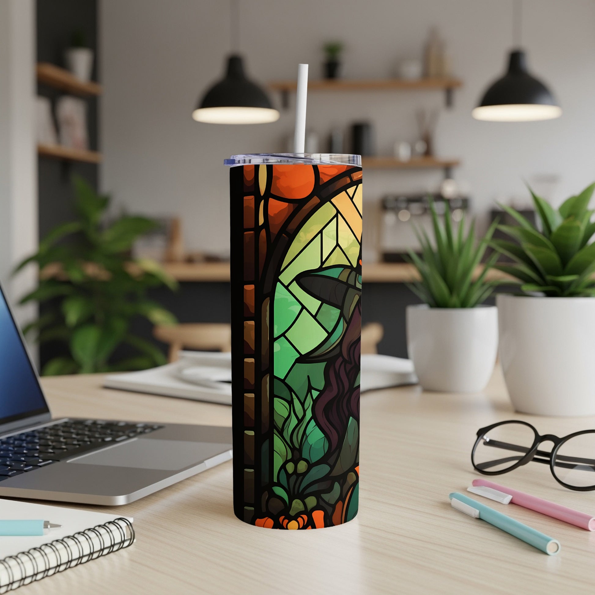 Stained glass tumbler with witch and pumpkin design.