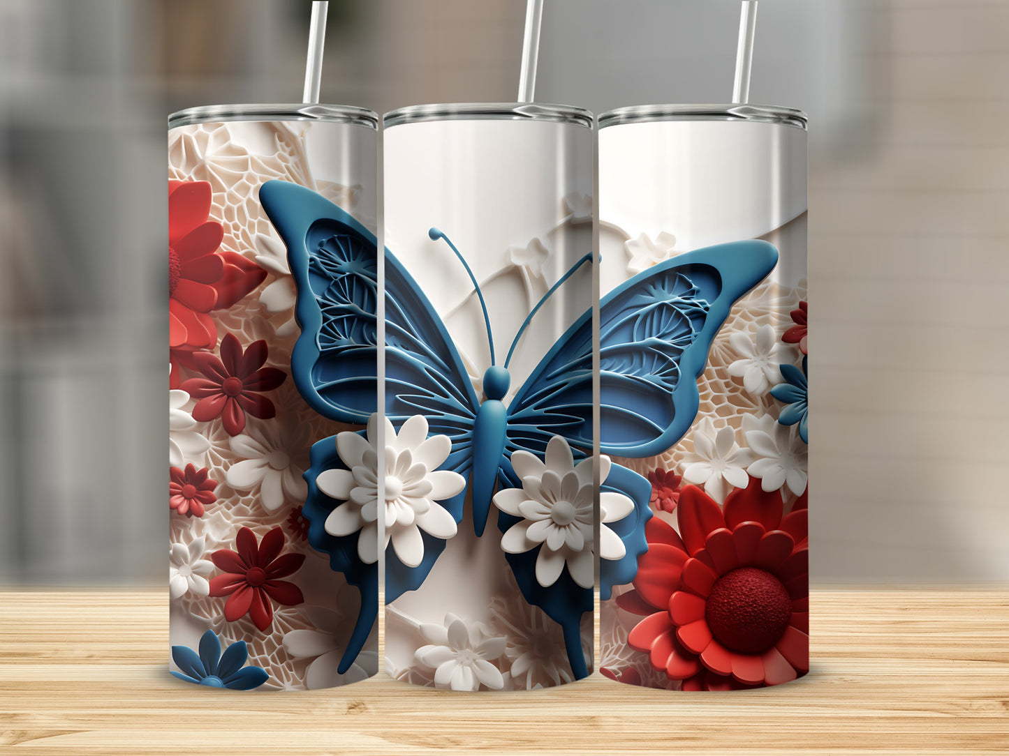 Three white tumblers with red and white floral patterns and blue butterfly designs.