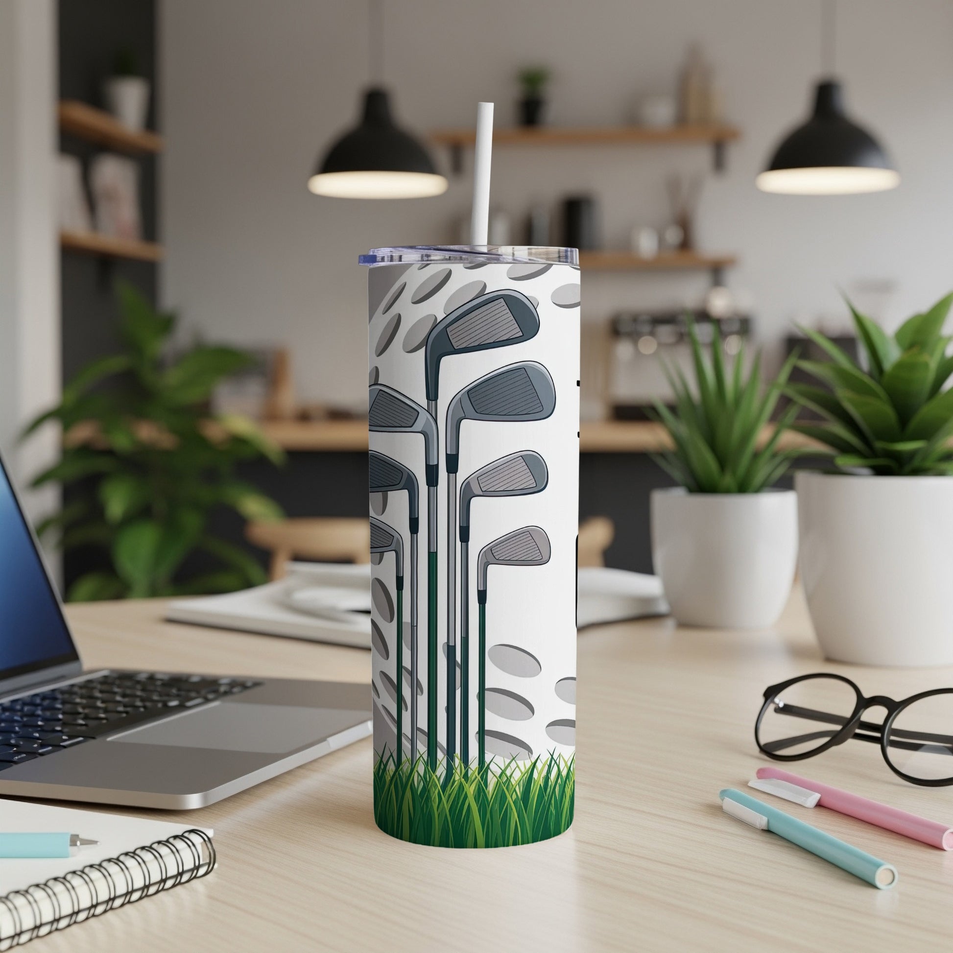 Tall tumbler with golf club design and white lid.