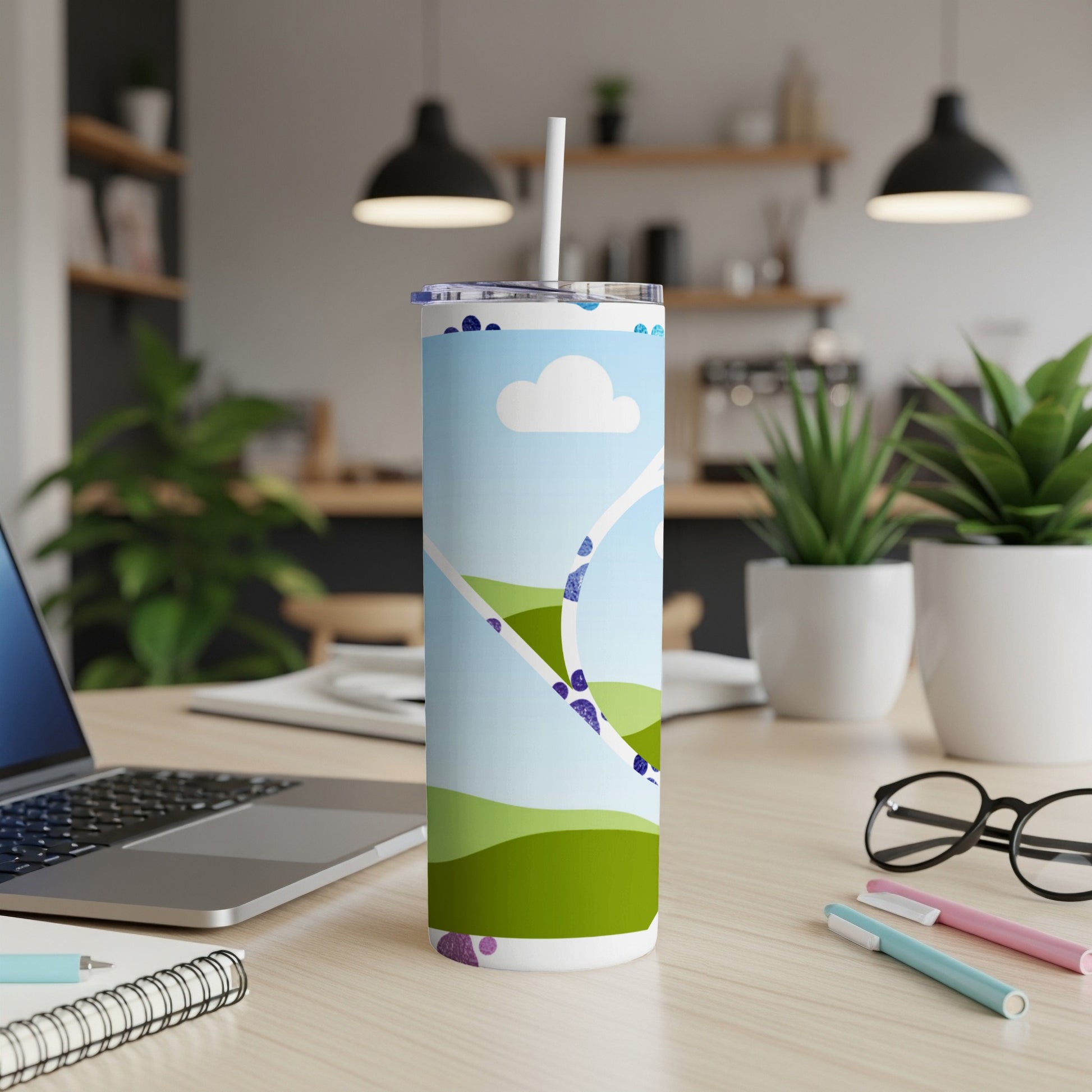 Tall tumbler with a blue sky, clouds, and green rolling hills graphic.