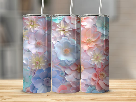 Three tumblers with pastel floral designs sit on a wooden surface.