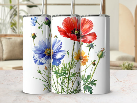 Three white tumblers decorated with vibrant poppies and blue and yellow wildflowers.