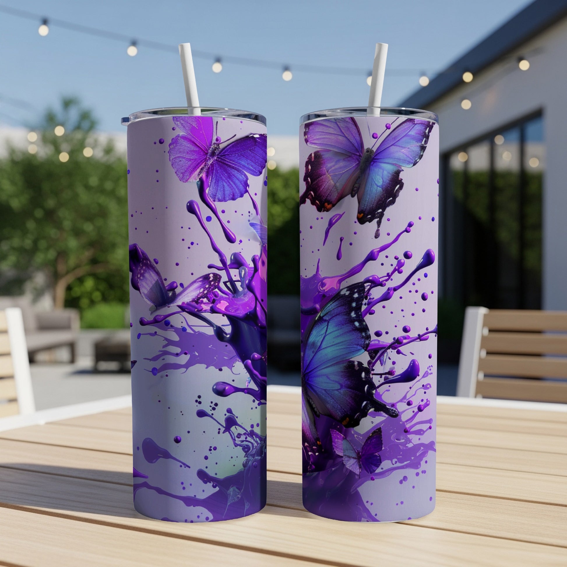 Two purple butterfly tumblers with purple paint splatters.
