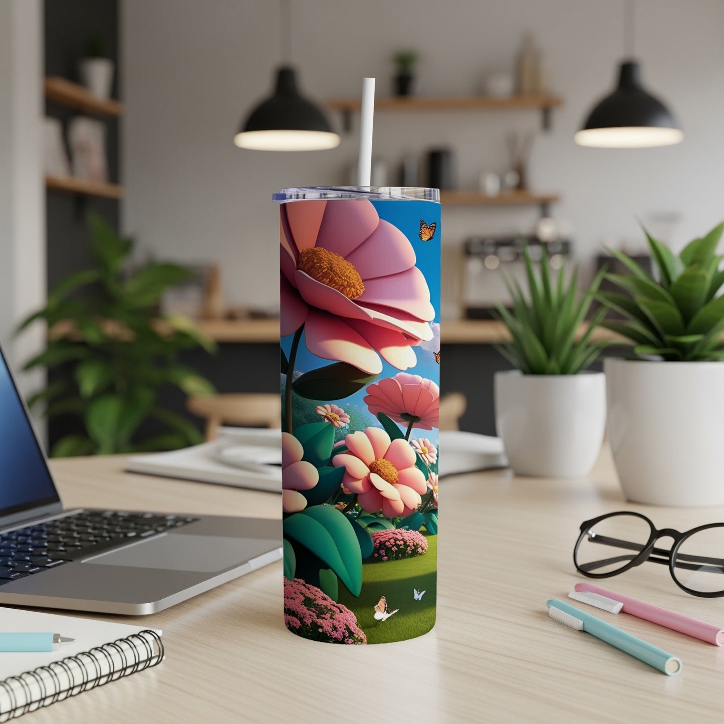 Tumbler with large pink flowers and green leaves, butterflies, on a desk.