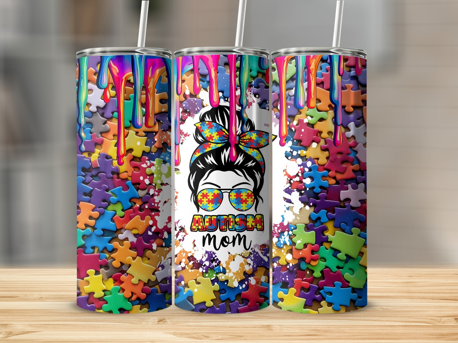 Three tumblers with colorful puzzle pieces and "Autism Mom" text.