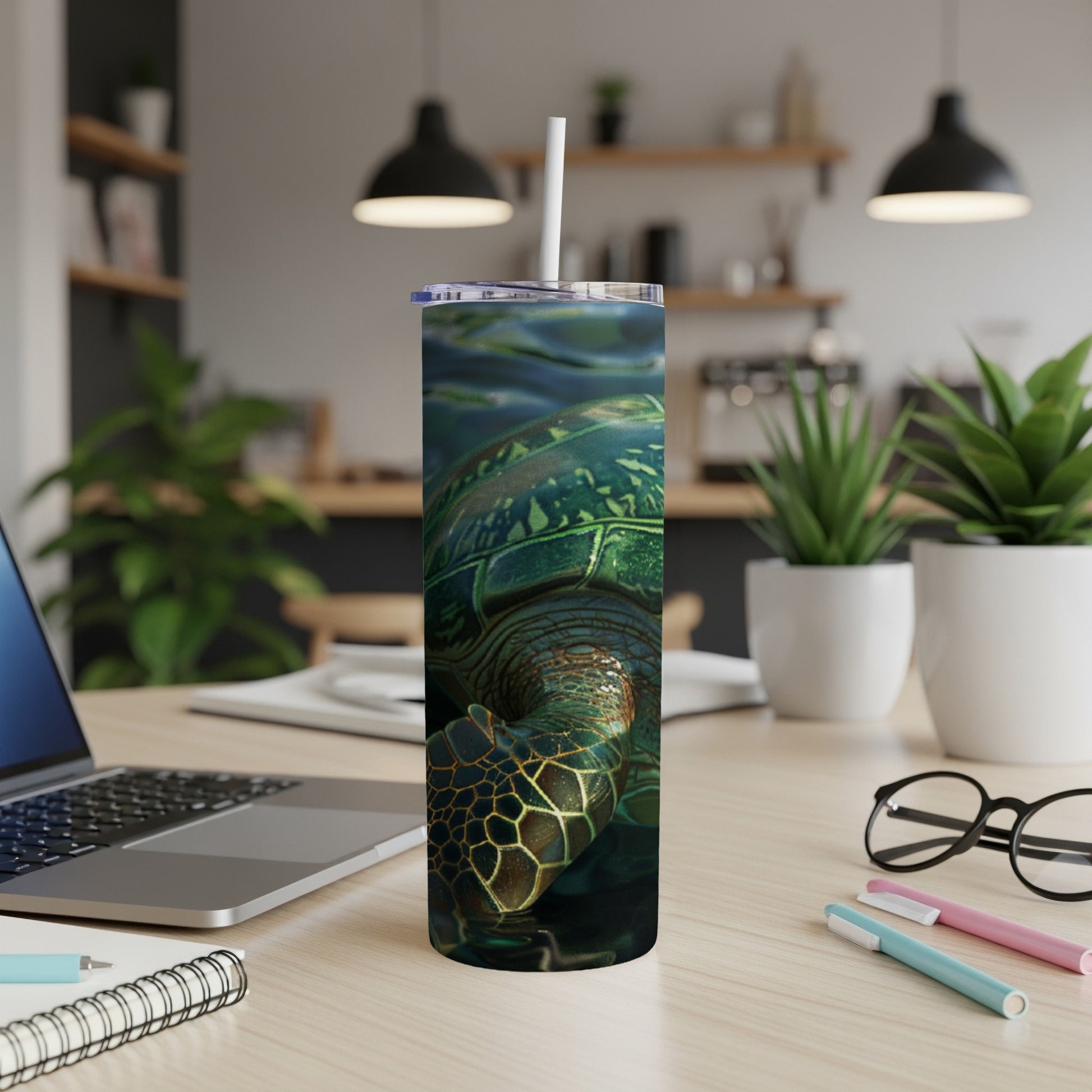 Green sea turtle on a tumbler with a straw on a desk.