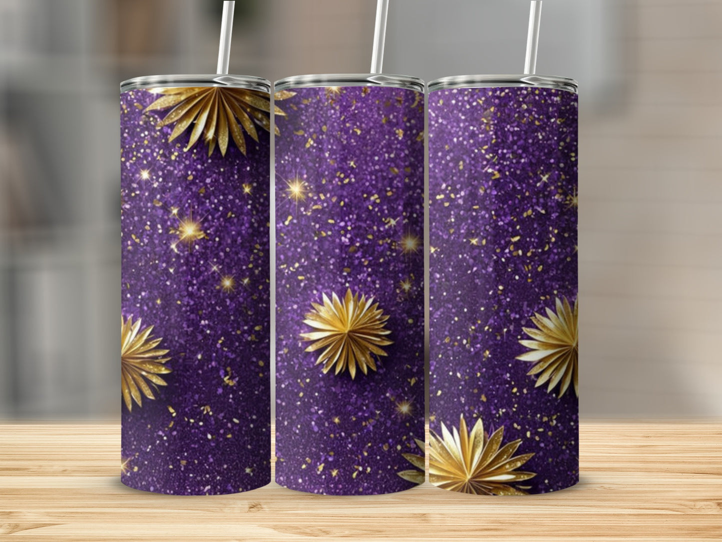 Three tumblers with purple glitter and gold starburst designs.