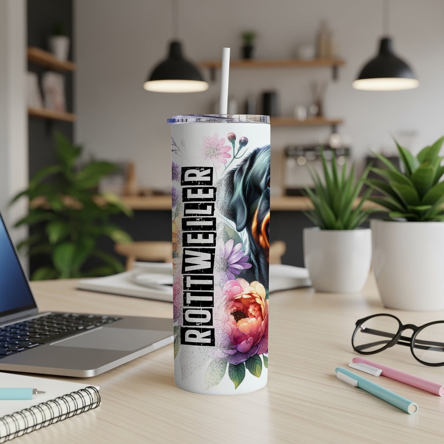 Rottweiler design on a white tumbler with floral accents.