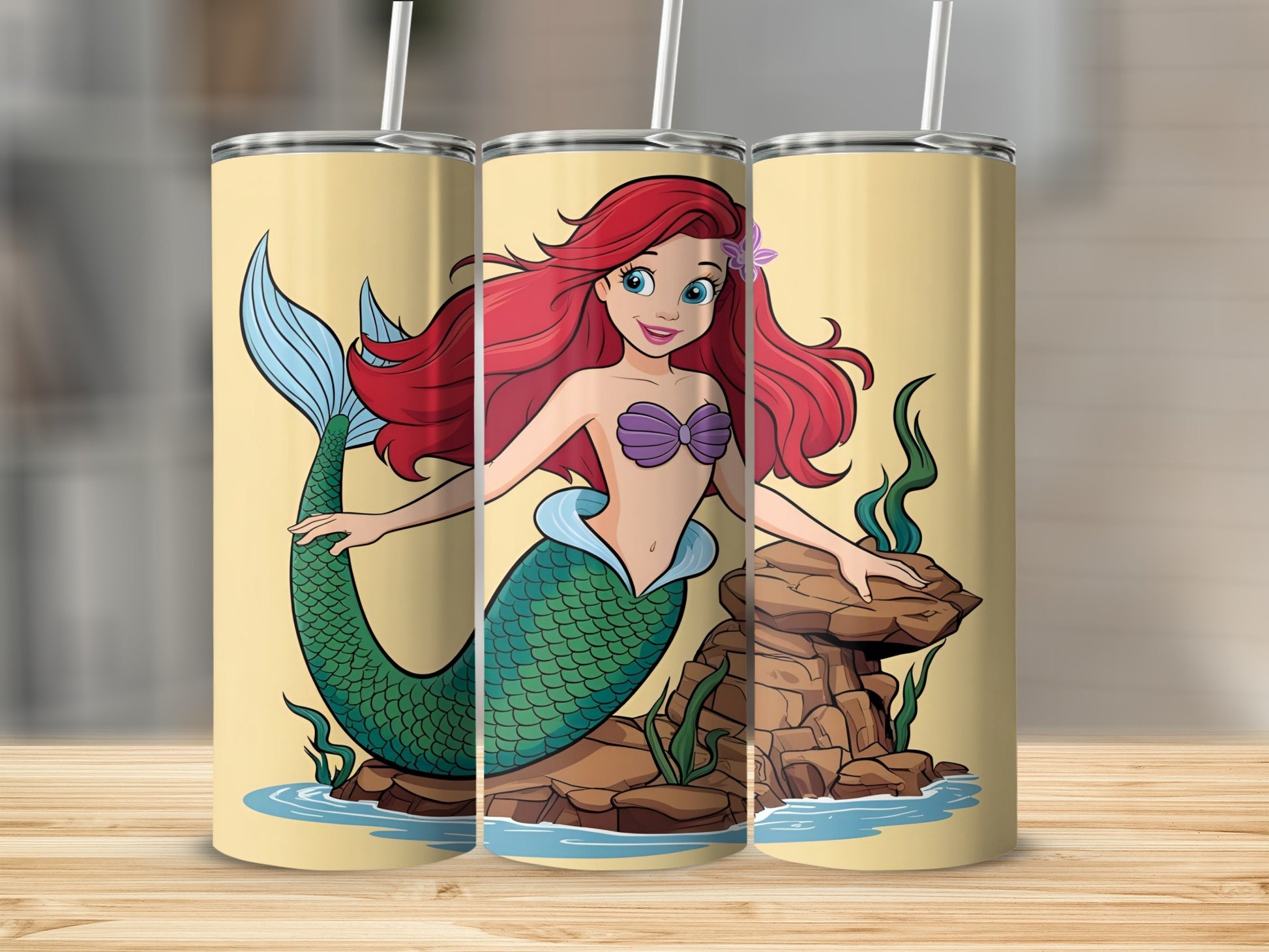Ariel the mermaid sits on rocks in the ocean.