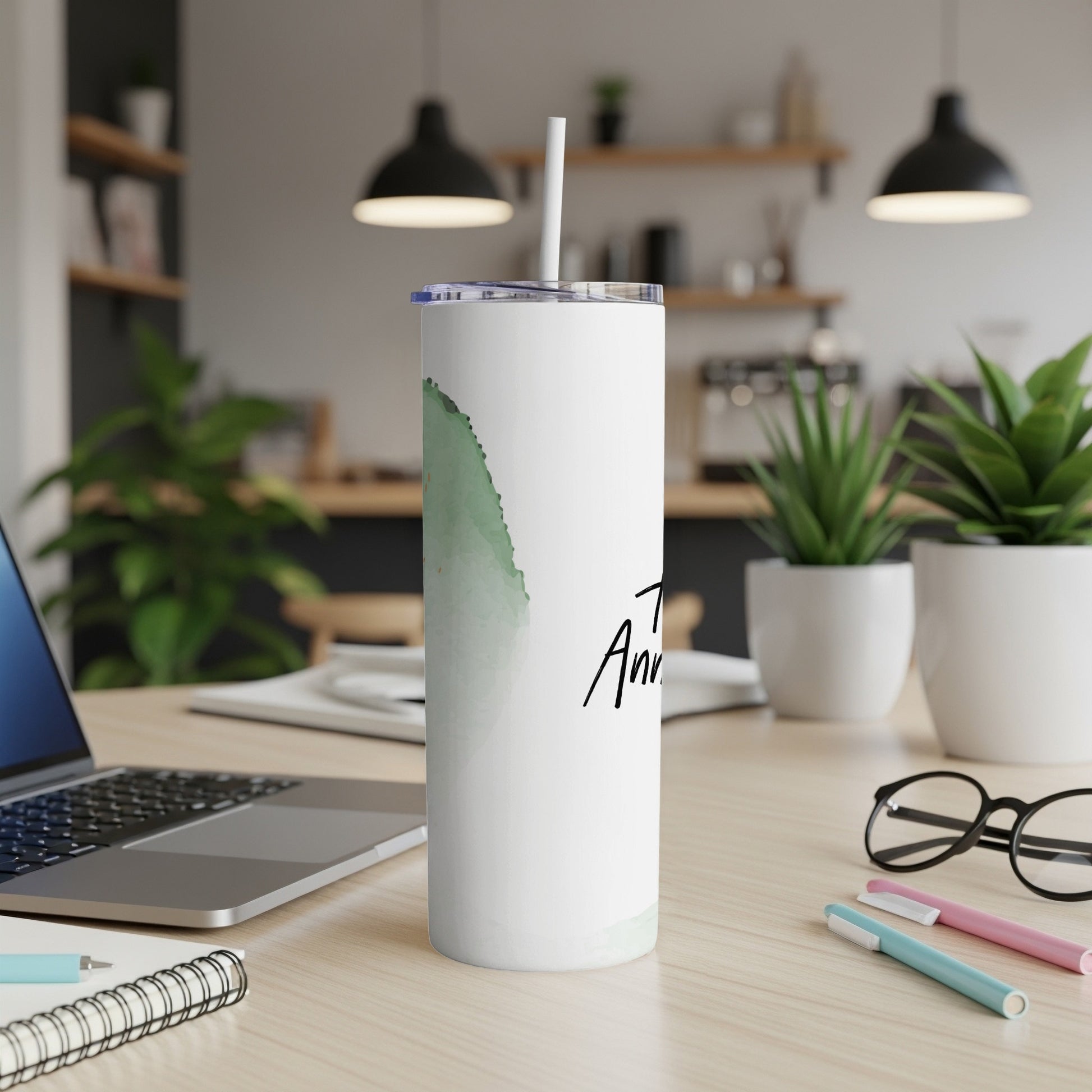 White tumbler with abstract green watercolor splash and "Anniversary" text.
