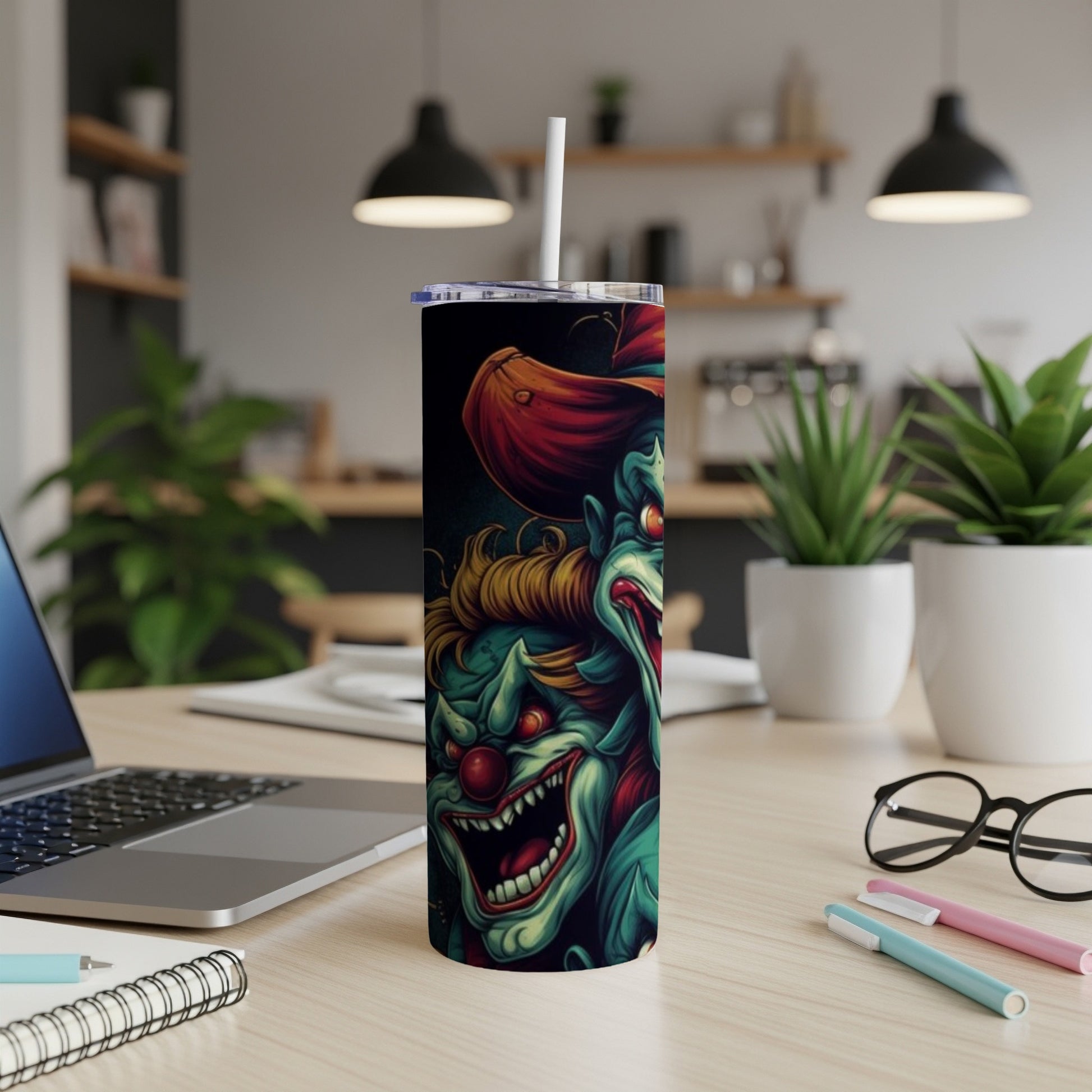 Tumbler with a creepy clown illustration featuring sharp teeth and red accents.