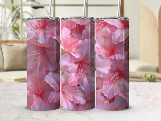 Three tumblers with pink floral pattern on a marble surface.