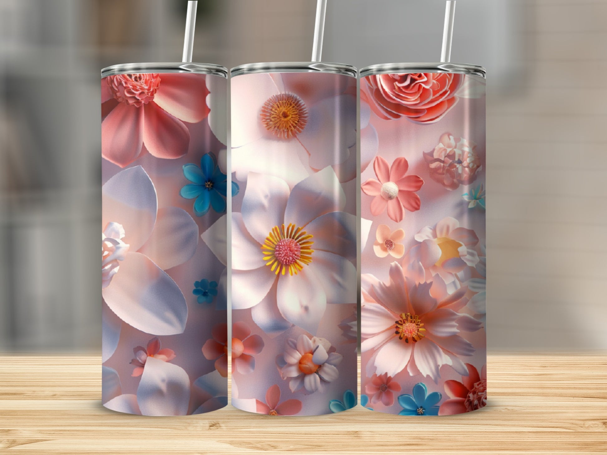 Three tumblers with floral designs featuring large pink and white flowers.