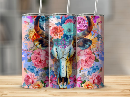 Floral cow skull design on three travel tumblers with straws.