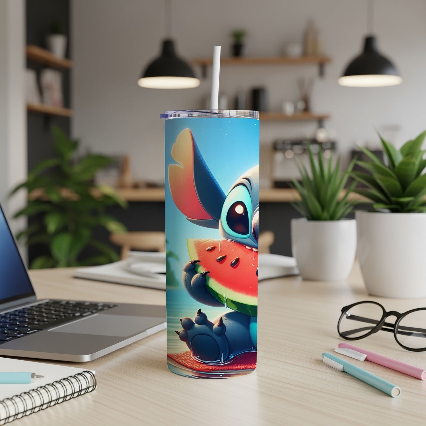 Stitch holding a slice of watermelon, seated on a beach towel.