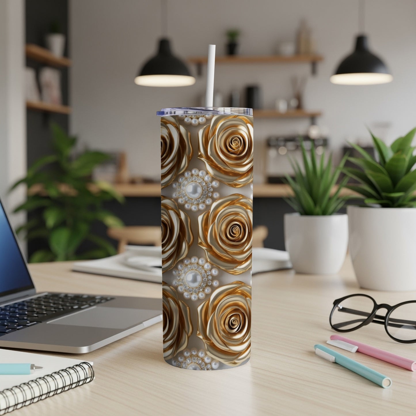 Gold roses with pearl accents wrap a stainless steel tumbler with a straw.