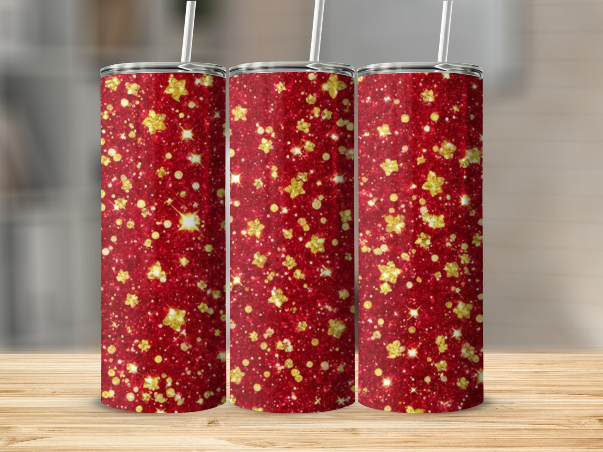 Three red tumblers with gold glitter star pattern.