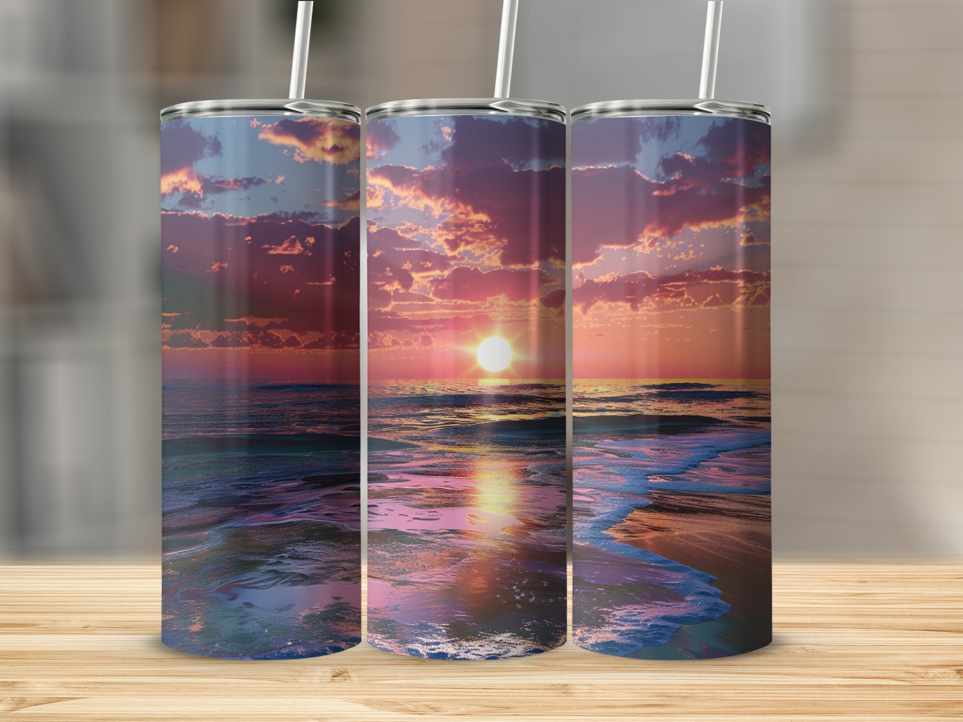 Three tumblers with a sunset ocean scene and a light reflection.