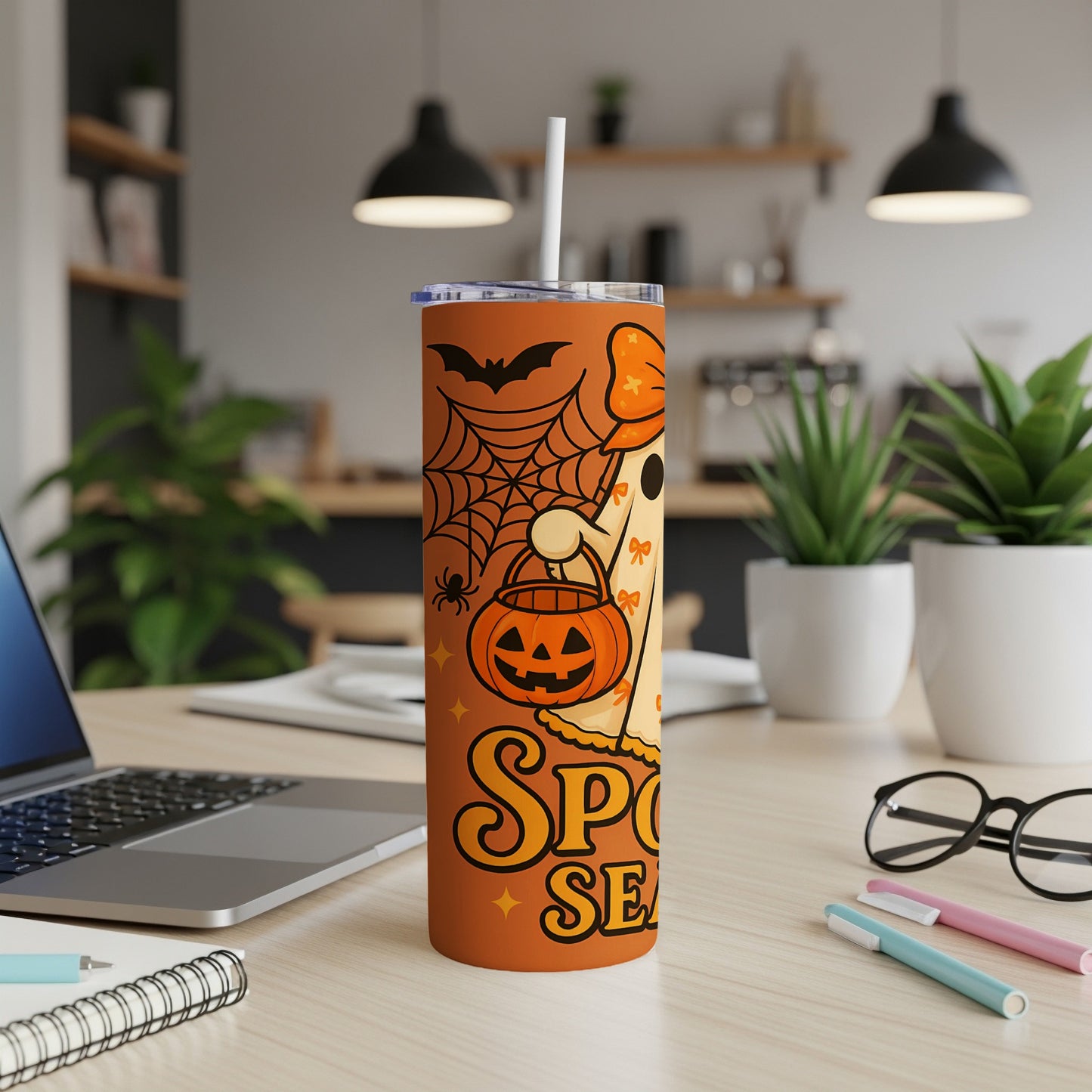 Orange Halloween tumbler with ghost, pumpkin, spider, bat, and text "Spooky Season".