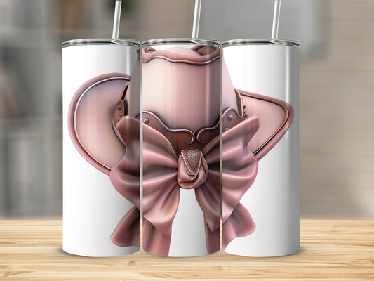 Pink cowboy hat with bow and embellishments on a tumbler.