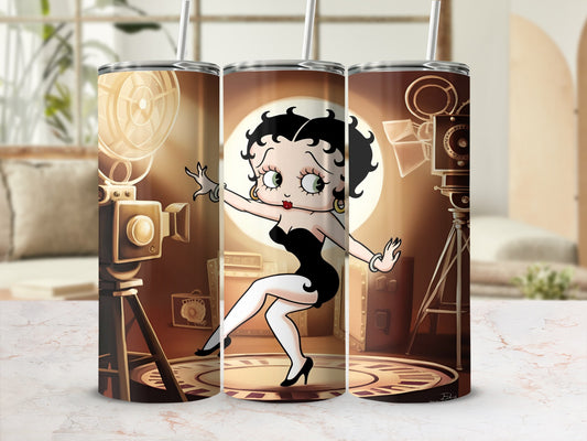 Betty Boop in a black dress on a spotlighted stage with film projectors.