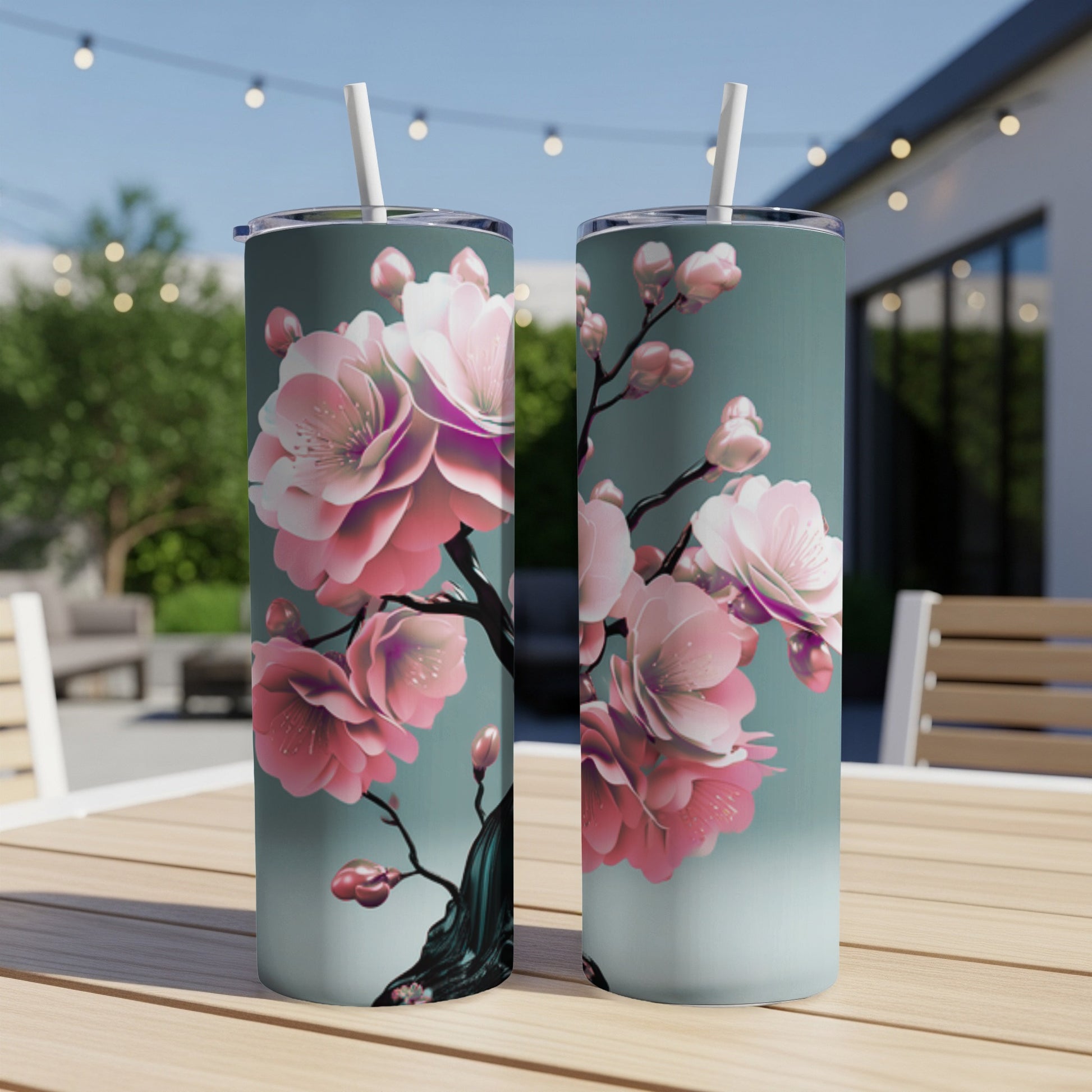 Two tumblers featuring a branch with pink cherry blossoms on a teal background.