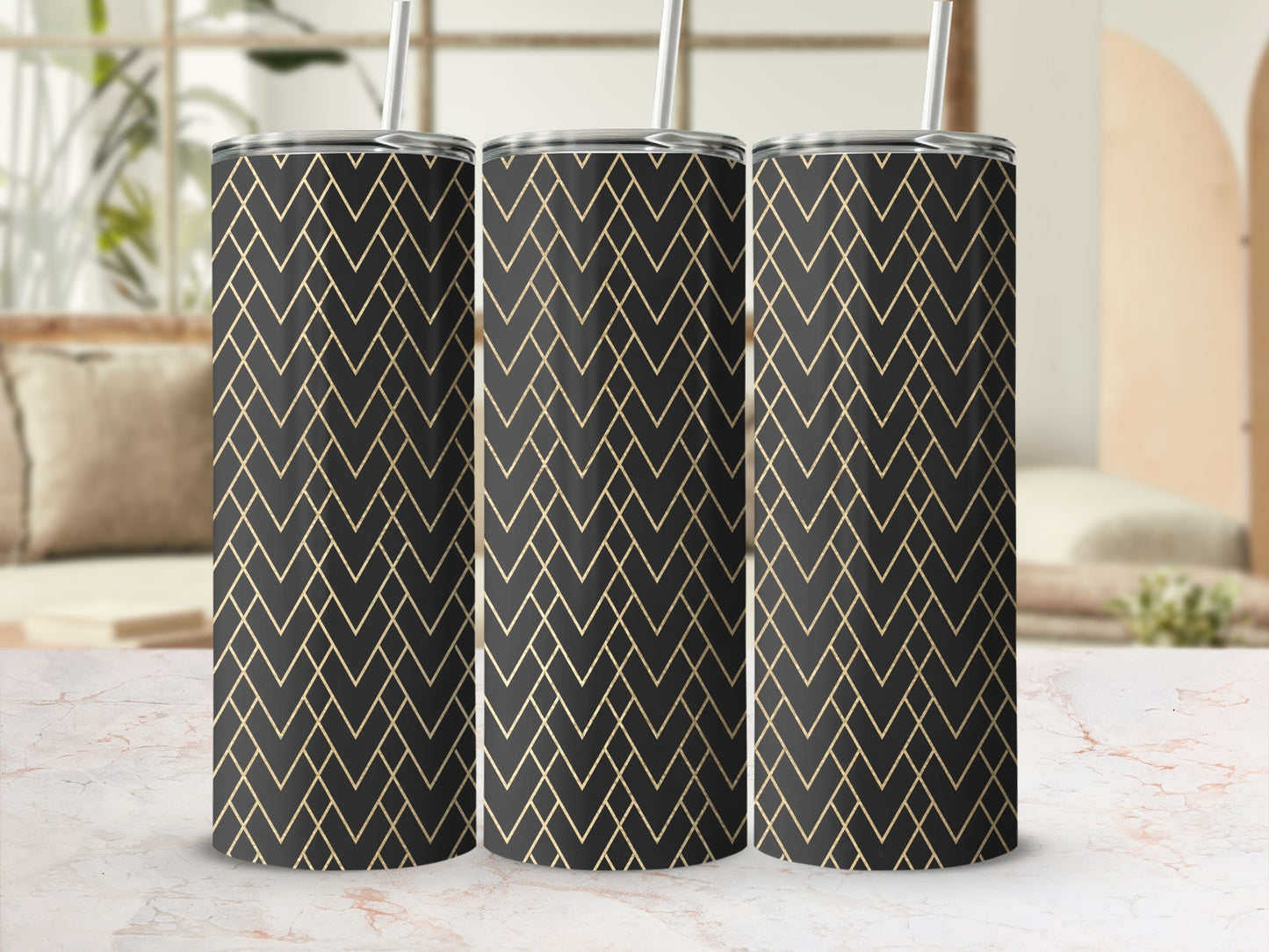 Three tumblers with black and gold geometric pattern on a marble surface.