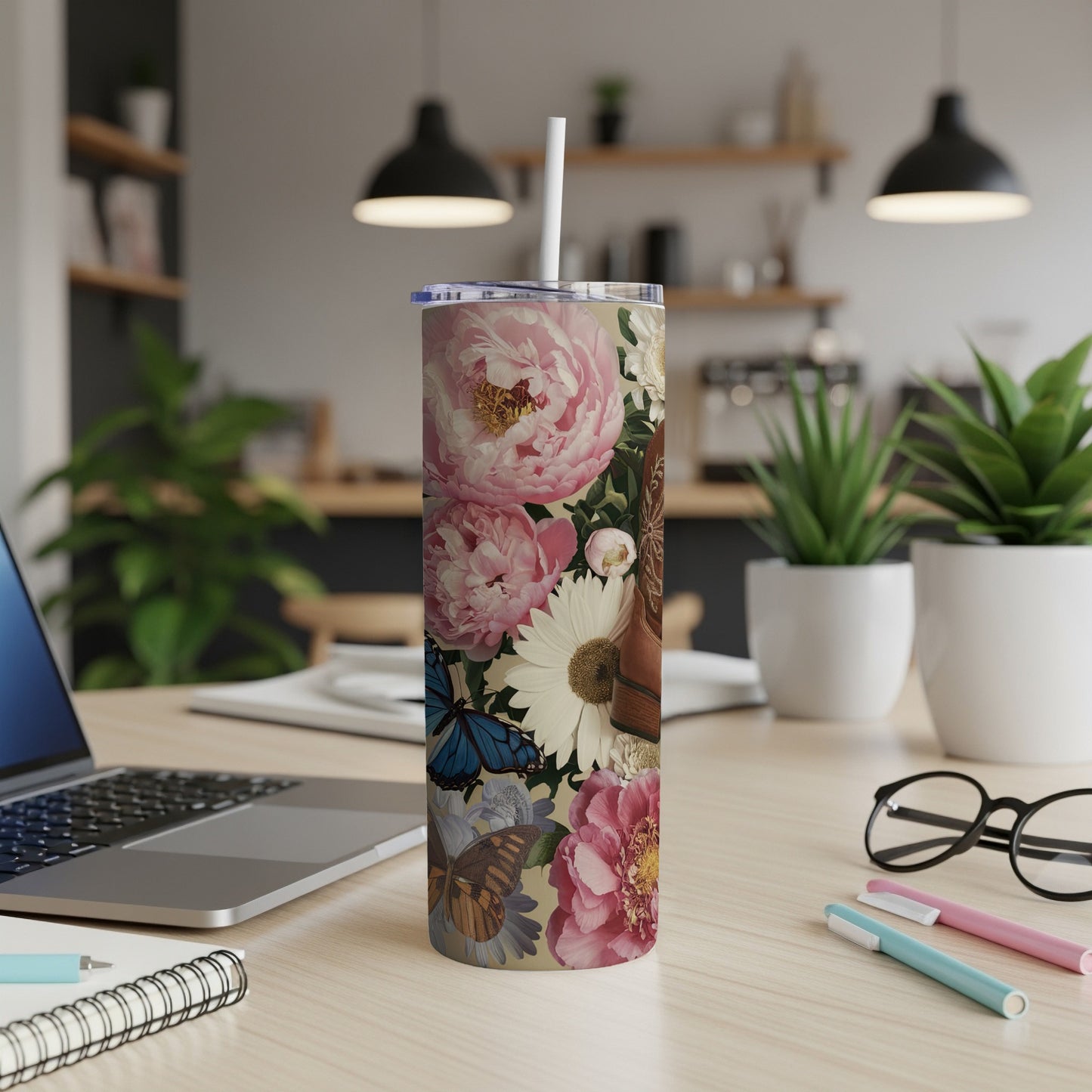 Floral design with butterflies and books on a white tumbler.