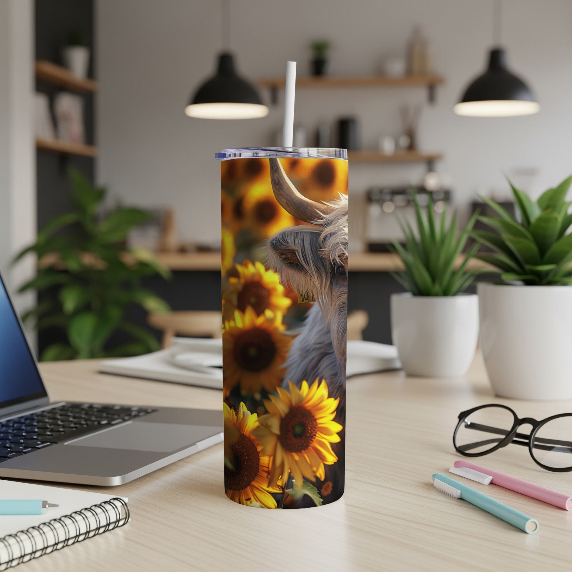 Highland cow with sunflowers on a tumbler with a straw.