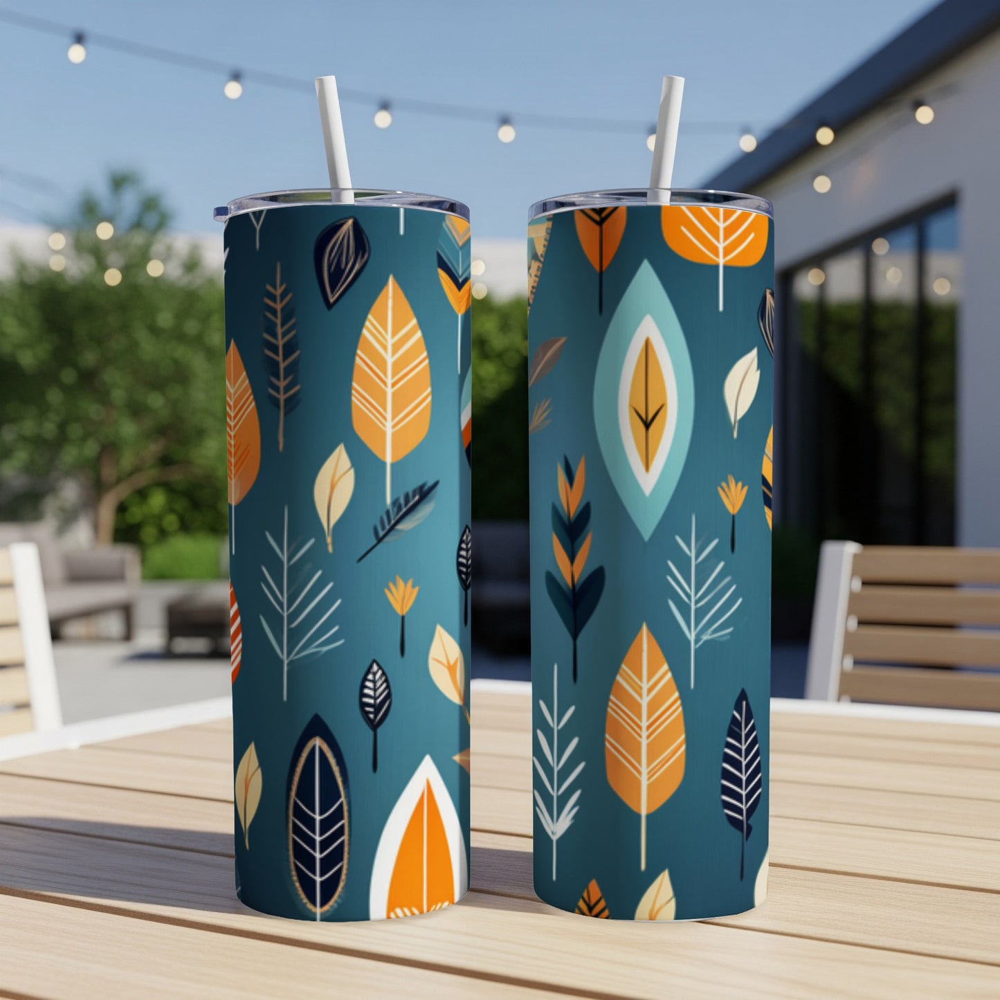 Two tall tumblers with a navy blue base and an abstract leaf pattern in orange and white.