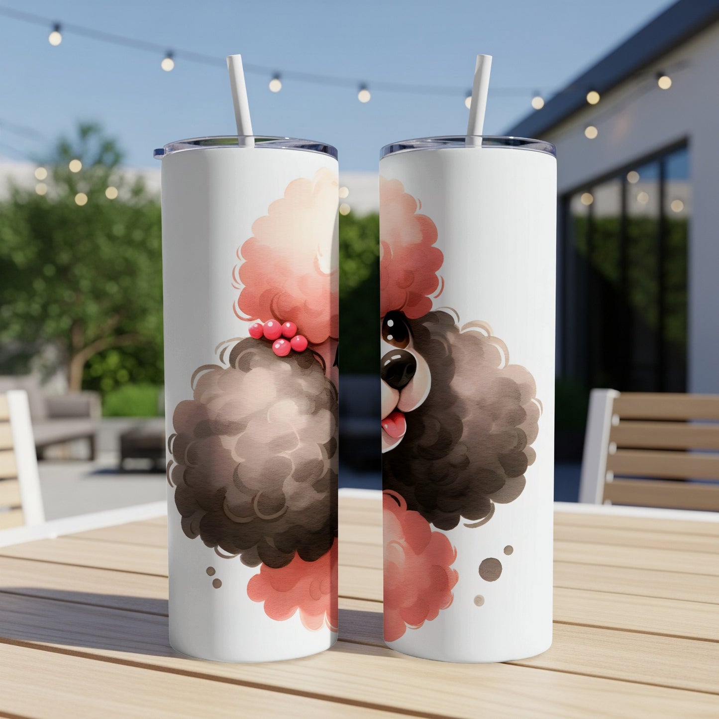 Two tumblers with a cartoon poodle design, resting on a wooden table outdoors.