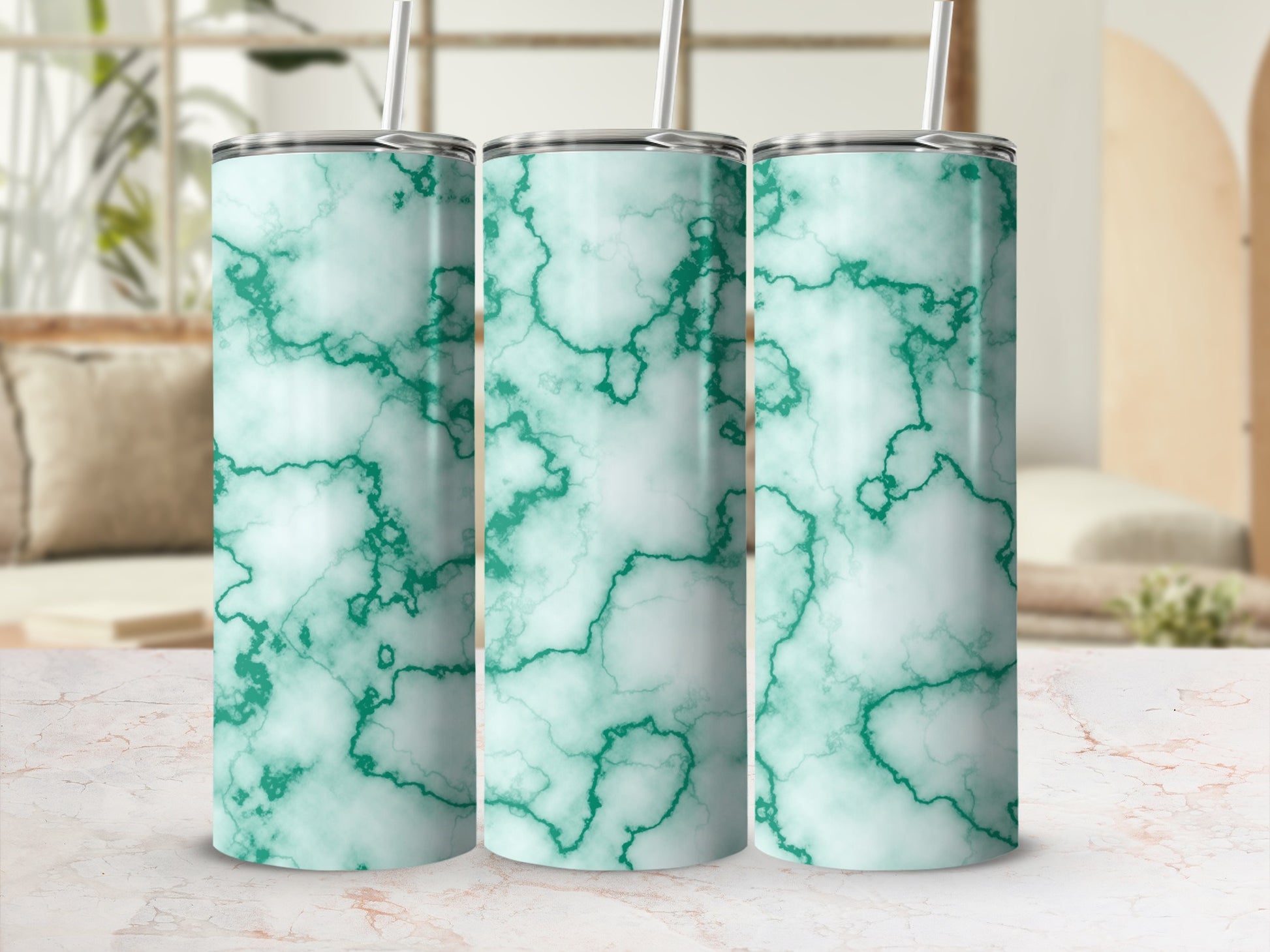 Three tall tumblers with green marble pattern in a bright setting.