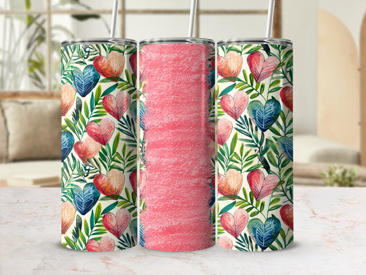 Three tumblers with heart and leaf pattern on marble surface.
