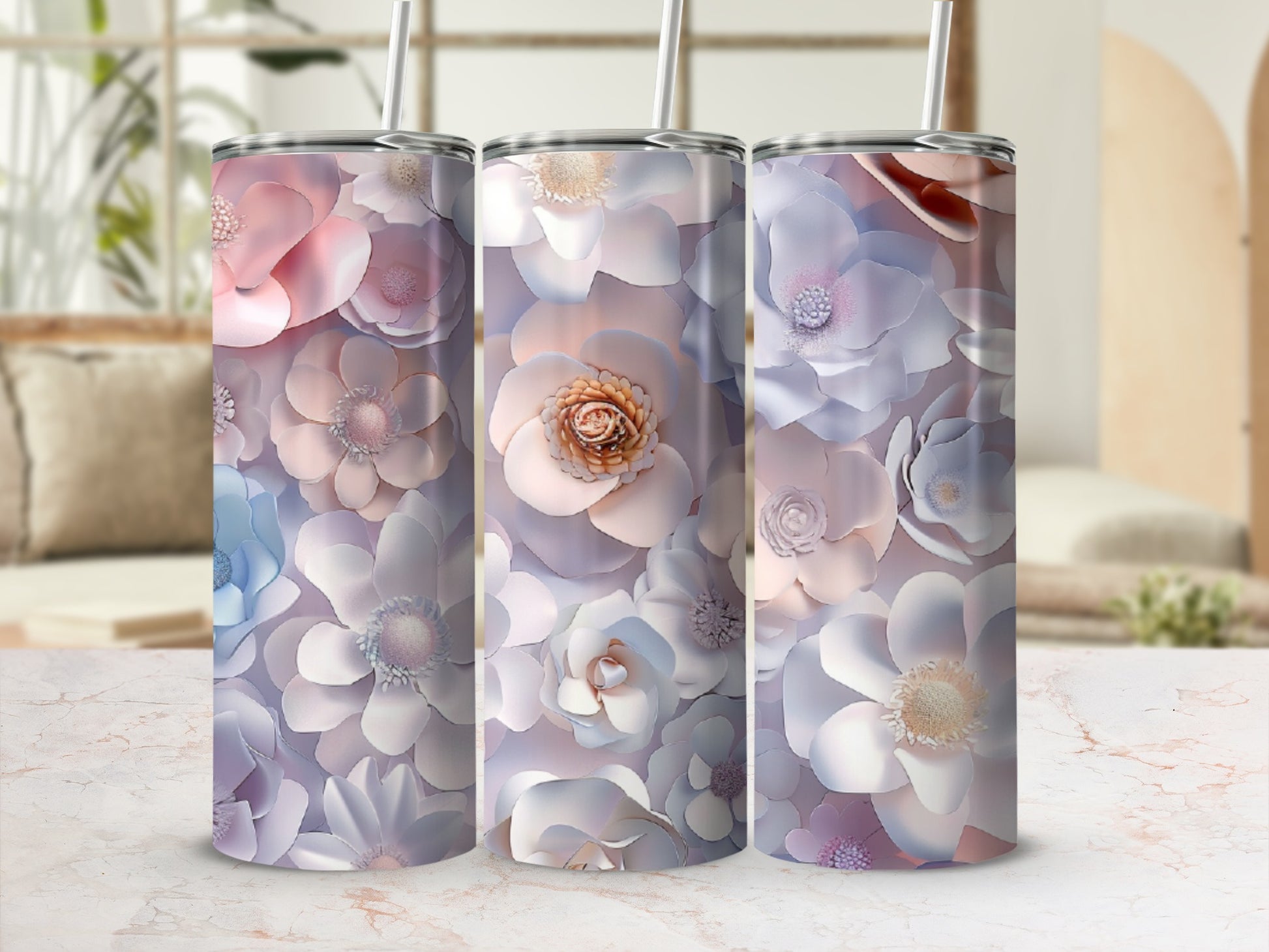 Three tumblers with pastel floral designs, featuring rose gold accents.