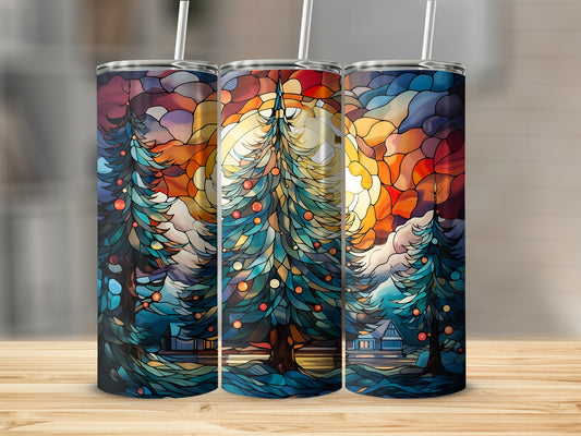 Three tumblers with stained glass Christmas tree design at sunset.