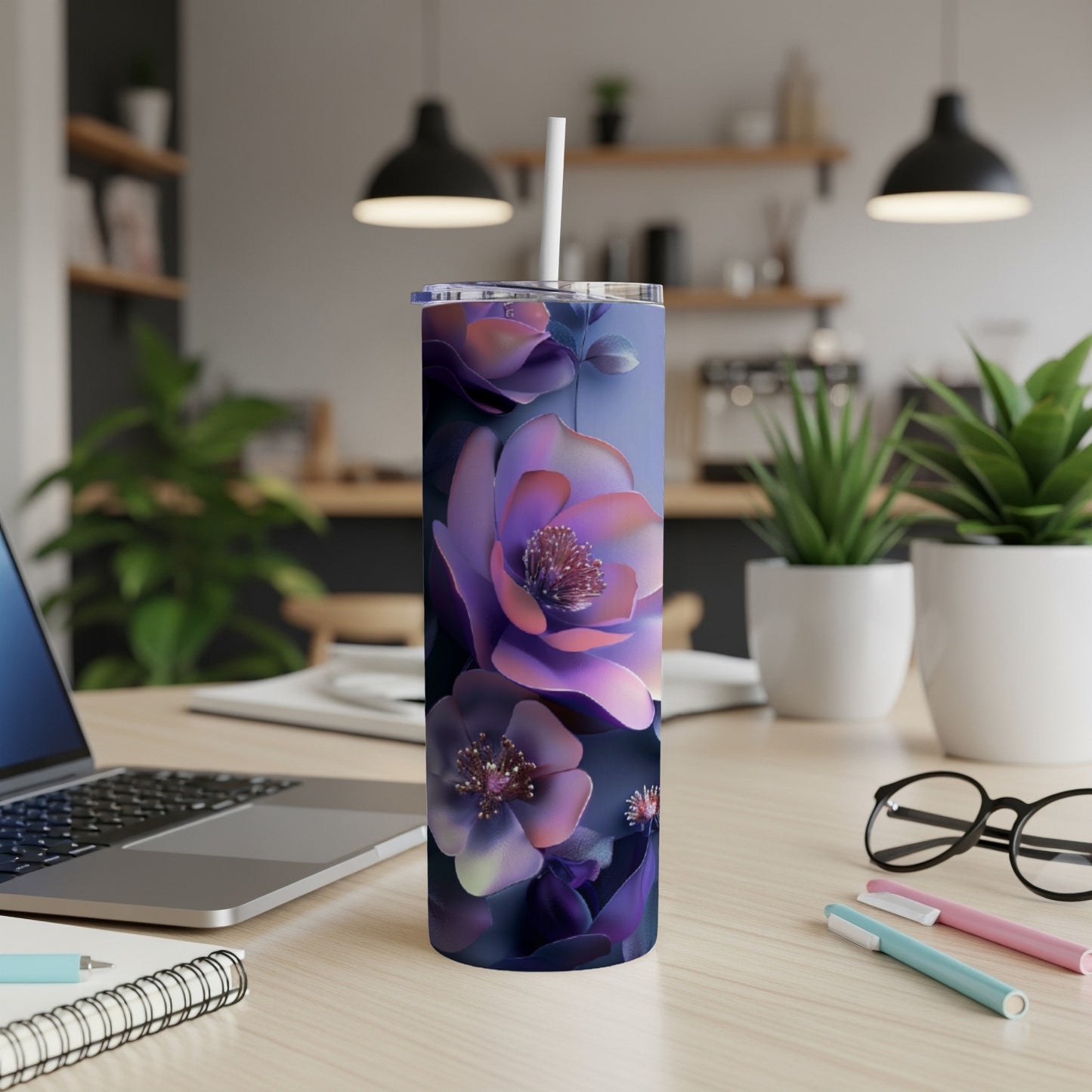 Purple floral tumbler with a white straw on a desk.