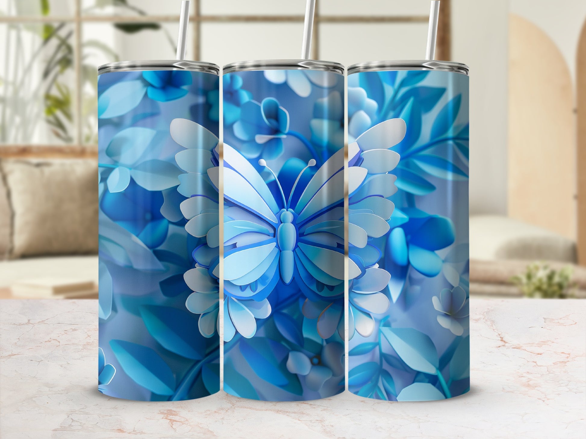 Blue butterfly and floral design on three tumblers with straws.