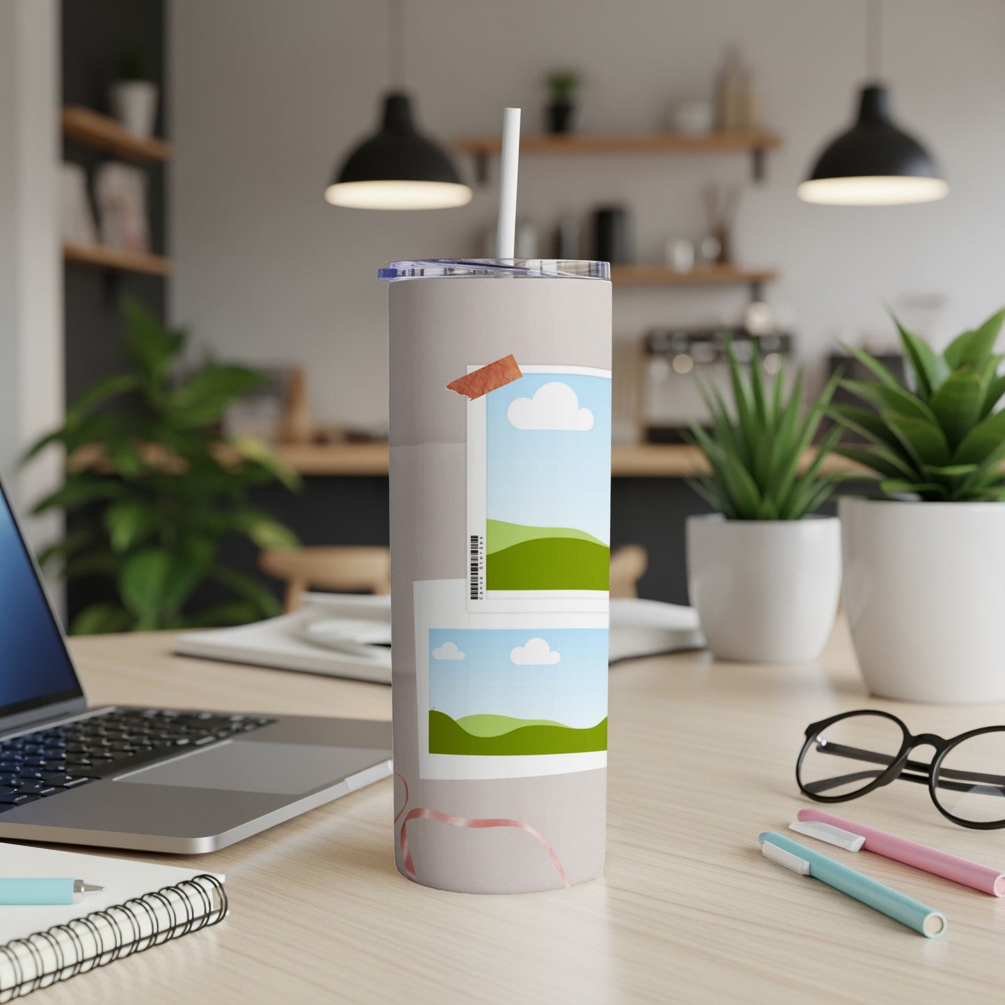 Light gray tumbler with two framed landscape photos, a straw, and a pink ribbon design.
