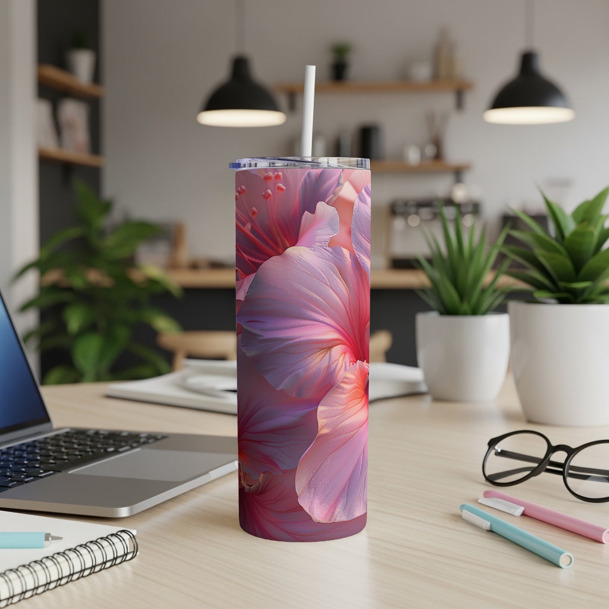 Pink hibiscus flower design on a white tumbler with a straw.
