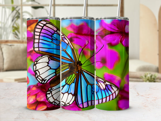Three tumblers with colorful butterfly and flower designs.
