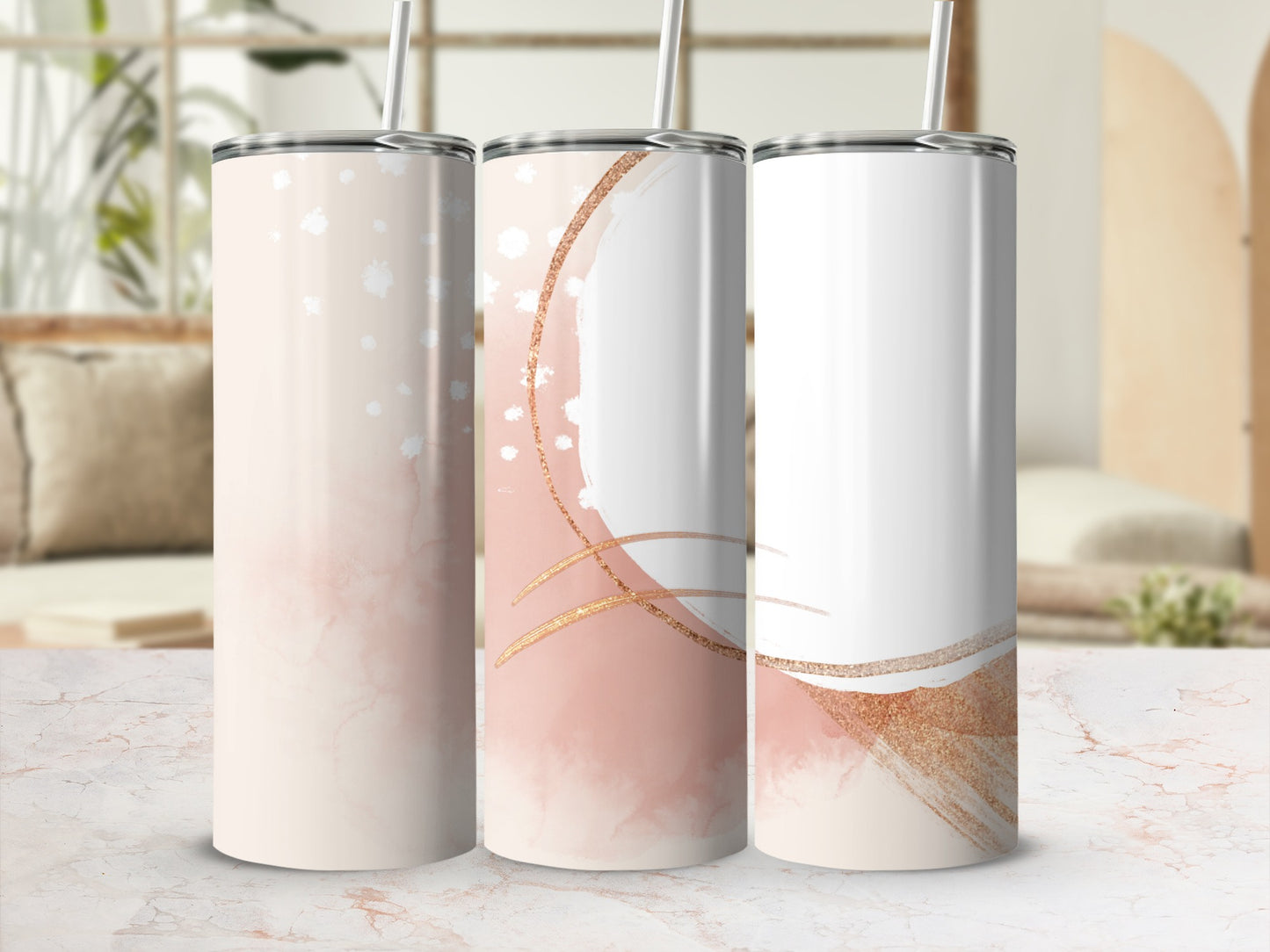Three sublimation tumblers with abstract pink and gold watercolor designs.