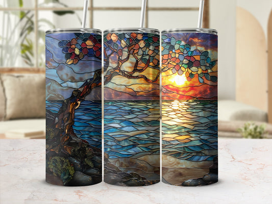 Three stained glass tumblers featuring a sunset tree scene on a marble surface.