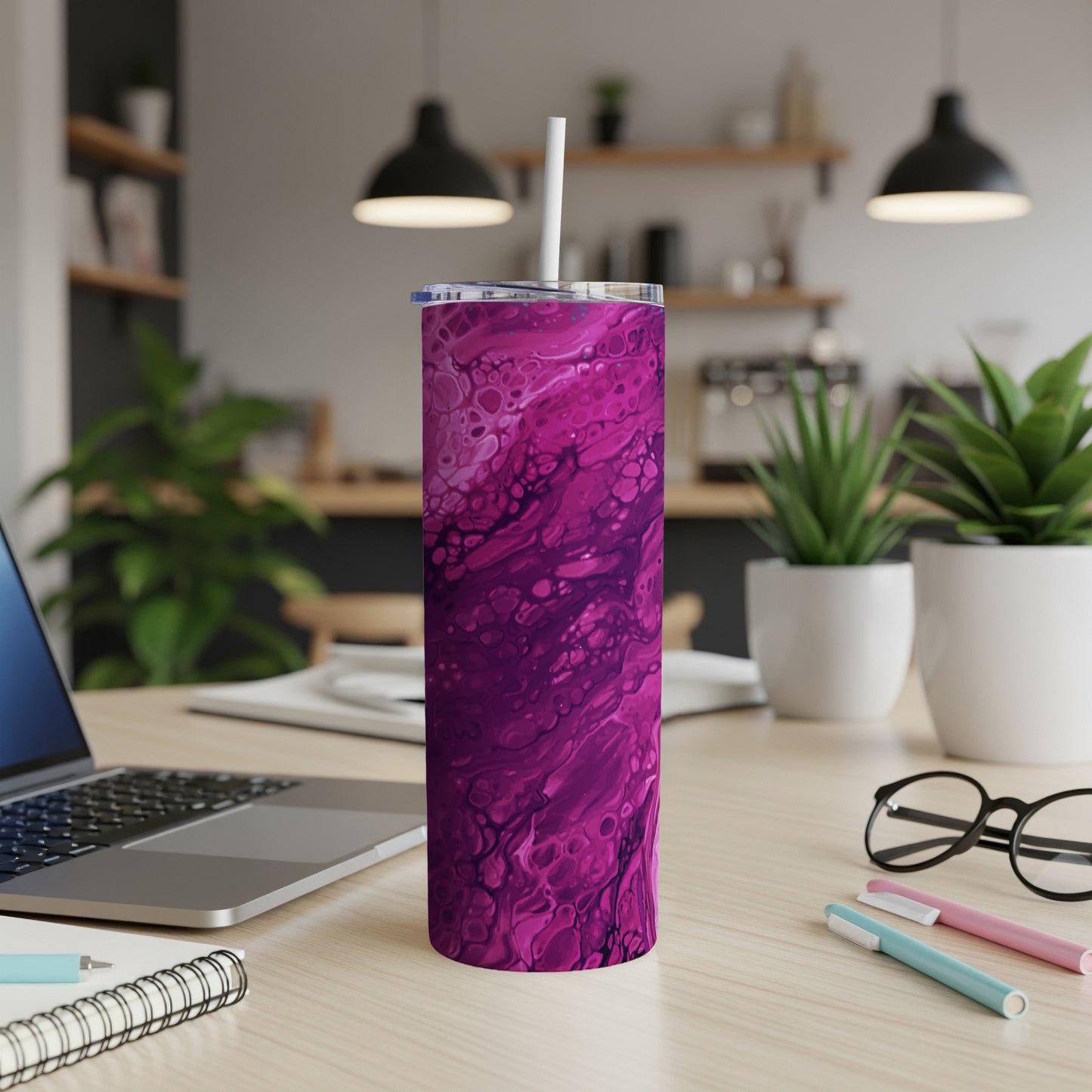 Tall tumbler with pink and purple abstract pattern and white straw.