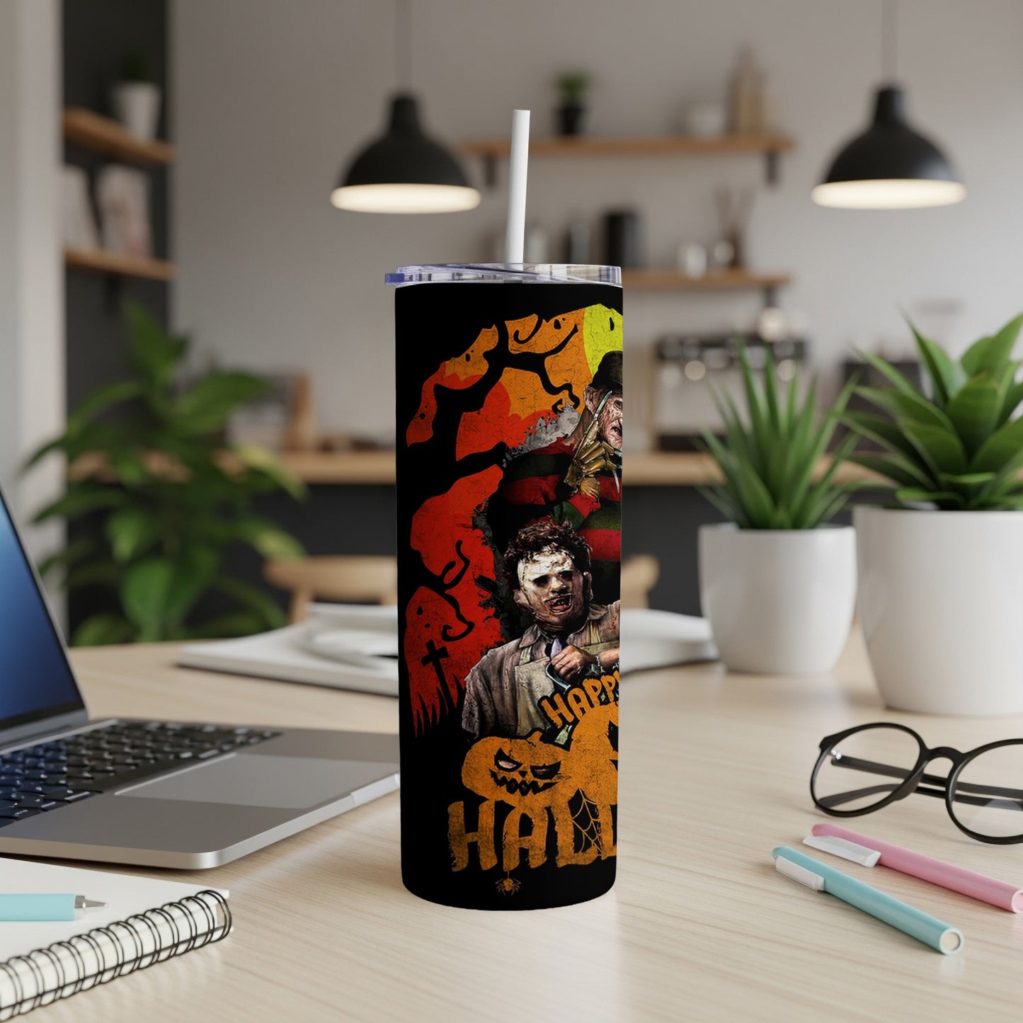 Tumbler with horror villains Freddy Krueger and Leatherface, and Halloween graphics.