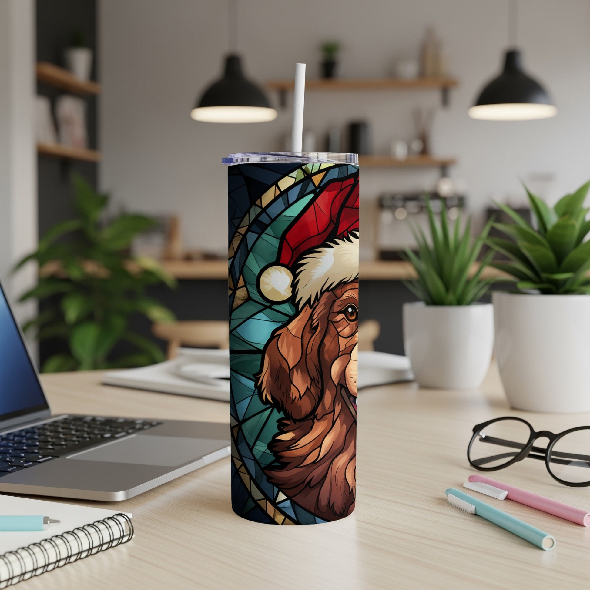 Dog in Santa hat on stained glass style tumbler, on desk.